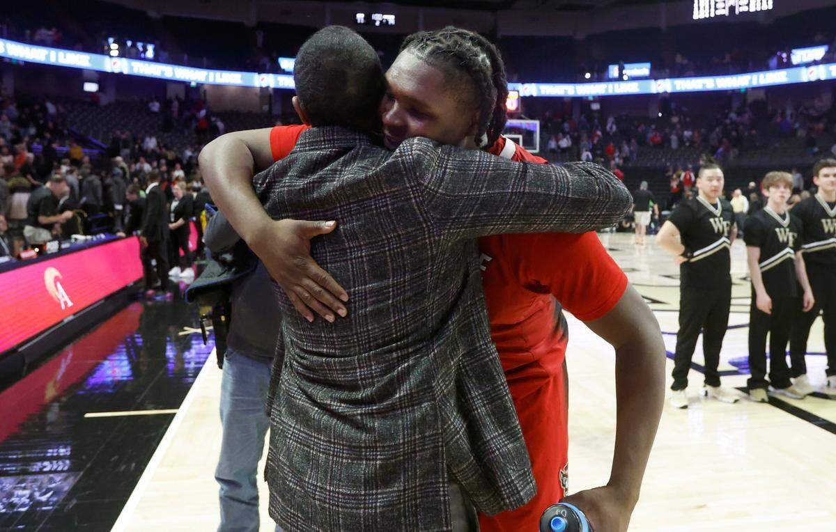 N.C. State’s head coach Kevin Keatts hugs D.J. Burns Jr. (30) after N.C. State’s 79-77 victory over Wake Forest at Joel Coliseum in Winston-Salem, N.C., Saturday, Jan. 28, 2023.