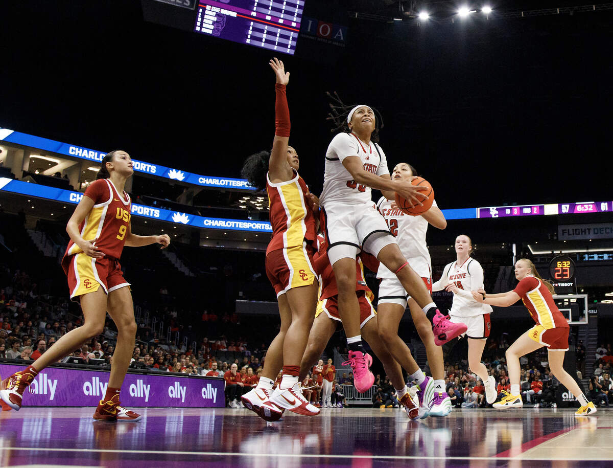 N.C. State’s Zoe Brooks drives to the basket past Southern California’s Malia Samuels during the second half of the Wolfpack’s 69-68 loss in the Ally Tipoff game on Sunday, Nov. 9, 2025, at Spectrum Center in Charlotte, N.C.