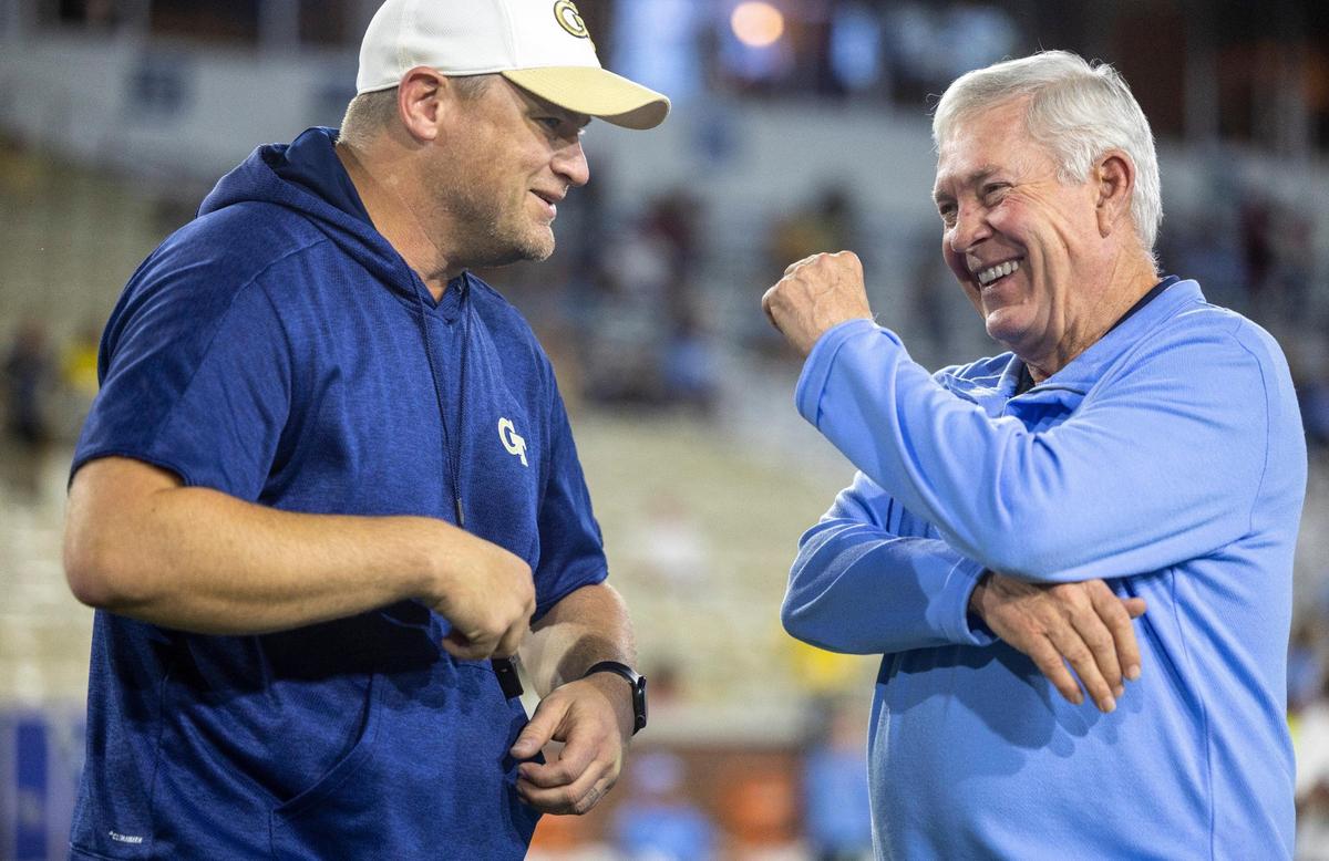 North Carolina coach Mack Brown talks with Georgia Tech coach Brent Key prior to their game on Saturday, October 28, 2023 at Bobby Dodd Stadium in Atlanta, Georgia.