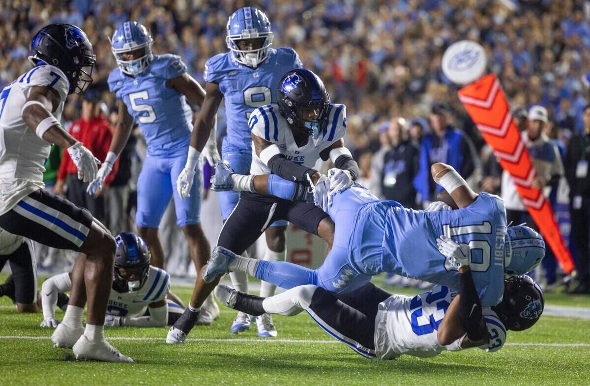 Duke’s Dawson Andrew (33) stops Bryson Nesbit (18) picks up eight yards after a pass from quarterback Drake Maye in the first quarter against Duke on Saturday, Nov. 11, 2023 at Kenan Stadium in Chapel Hill, N.C.