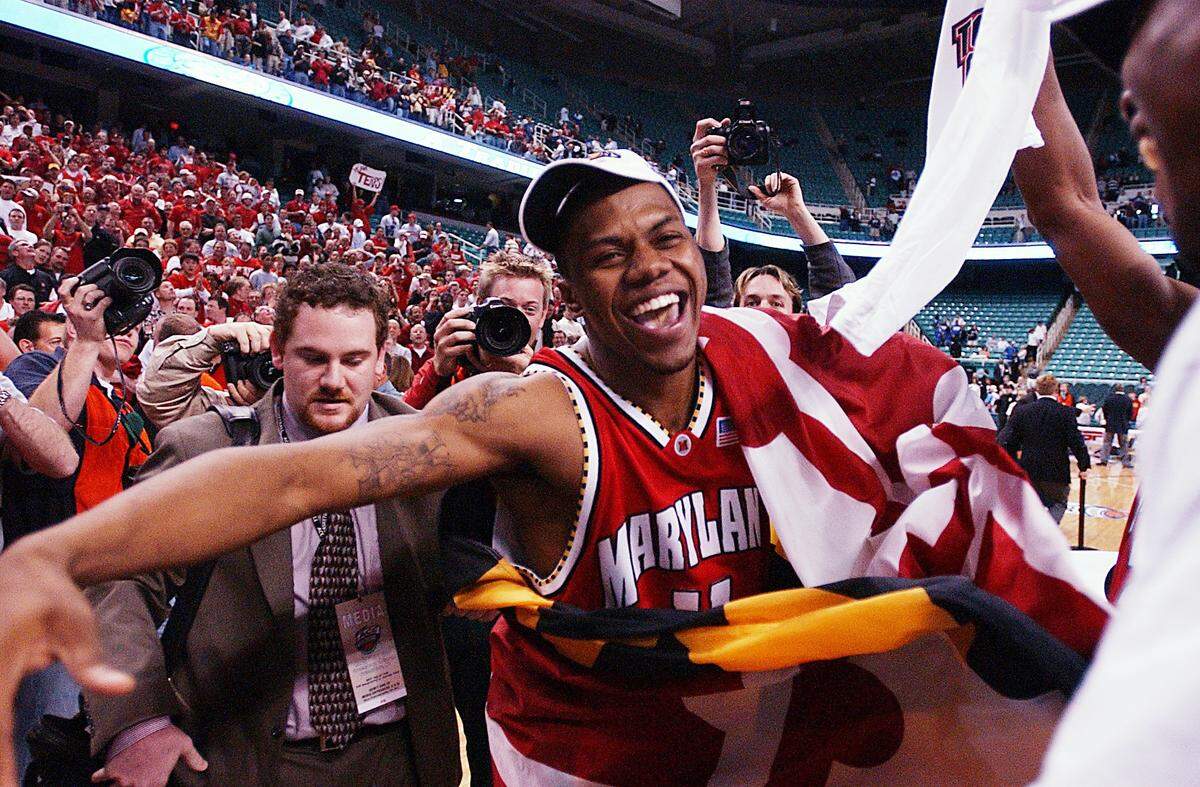 Maryland's John Gilchrist, the ACC tournament MVP, celebrates with teammates after the Terrapins defeated Duke, 95-87, in overtime to win the ACC Championship on Sunday afternoon, March 14, 2004, at the Greensboro Coliseum in Greensboro, North Carolina. 