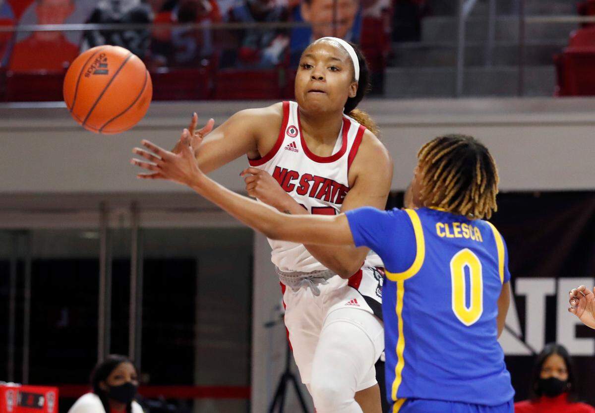 N.C. State’s Kayla Jones (25) passes around Pittsburgh’s Sandrine Clesca (0) during the second half of N.C. State’s 83-53 victory over Pittsburgh at Reynolds Coliseum in Raleigh, N.C., Thursday, February 25, 2021.