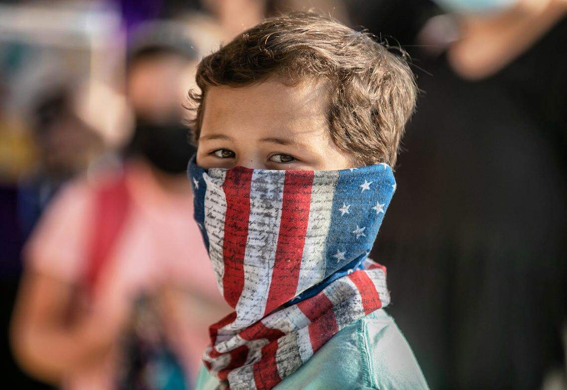 Korbin Stewart, a third-grader at Thanksgiving Elementary School, waits to enter the building for the first day of classes on Monday, August 23, 2021 in Selma, N.C.