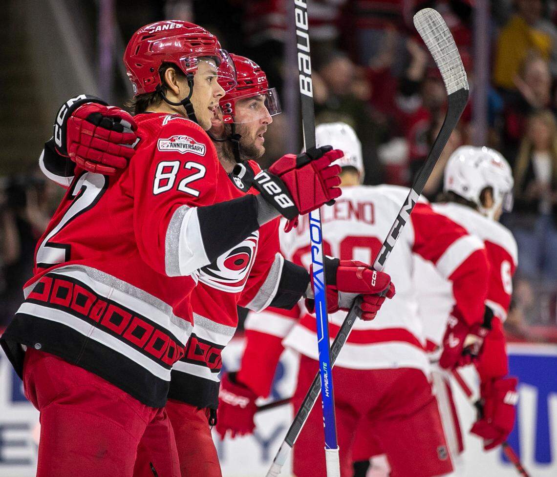 Carolina Hurricanes’ Stefan Noesen (23) embraces teammate Jesperi Kotkaniemi (82) after scoring on Detroit goalie Alex Nedeljkovic (39) to give the Hurricanes a 1-0 lead in the first period on Tuesday, April 11, 2023 at PNC Arena in Raleigh, N.C.