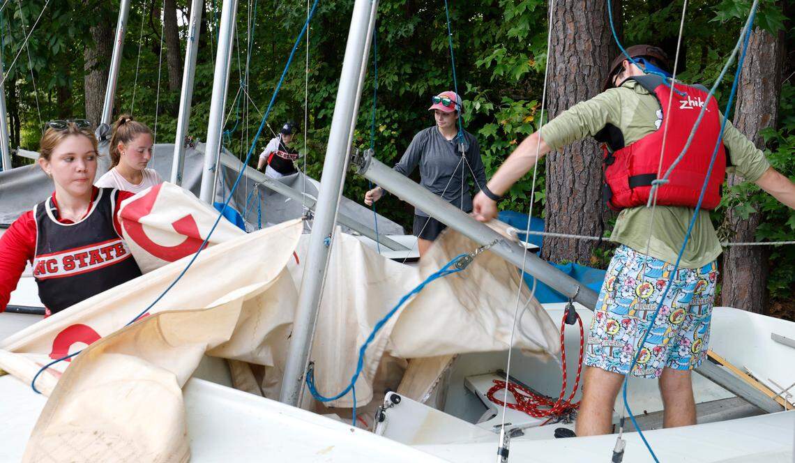 From left Julia Boutet, Olivia Soucy, Magnolia Smith, Lyla Solway and Liam Holder de-rig sailboats after the N.C. State sailing team practice at Lake Crabtree in Morrisville, N.C., Friday, Sept. 6, 2024.