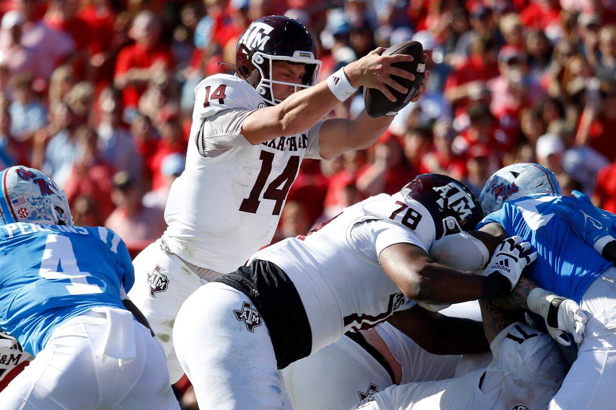 Nov 4, 2023; Oxford, Mississippi, USA; Texas A&M Aggies quarterback Max Johnson (14) reaches for the goal line for a touchdown during the second half against the Mississippi Rebels at Vaught-Hemingway Stadium. Mandatory Credit: Petre Thomas-USA TODAY Sports