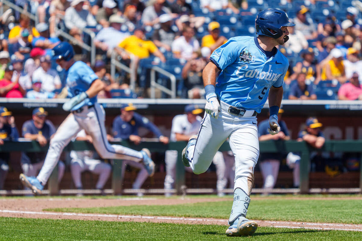 North Carolina Tar Heels second baseman Gavin Gallaher (5) runs to first as designated hitter Macon Winslow (6) scores against the West Virginia Mountaineers during the sixth inning at Charles Schwab Field.
