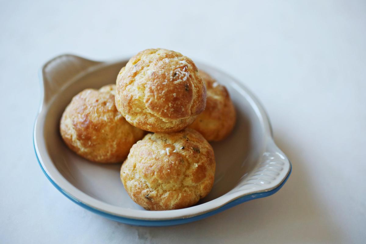 The gougères, light-as-air puffs of cheesy choux pastry, are delivered straight from the oven at Jolie in Raleigh.