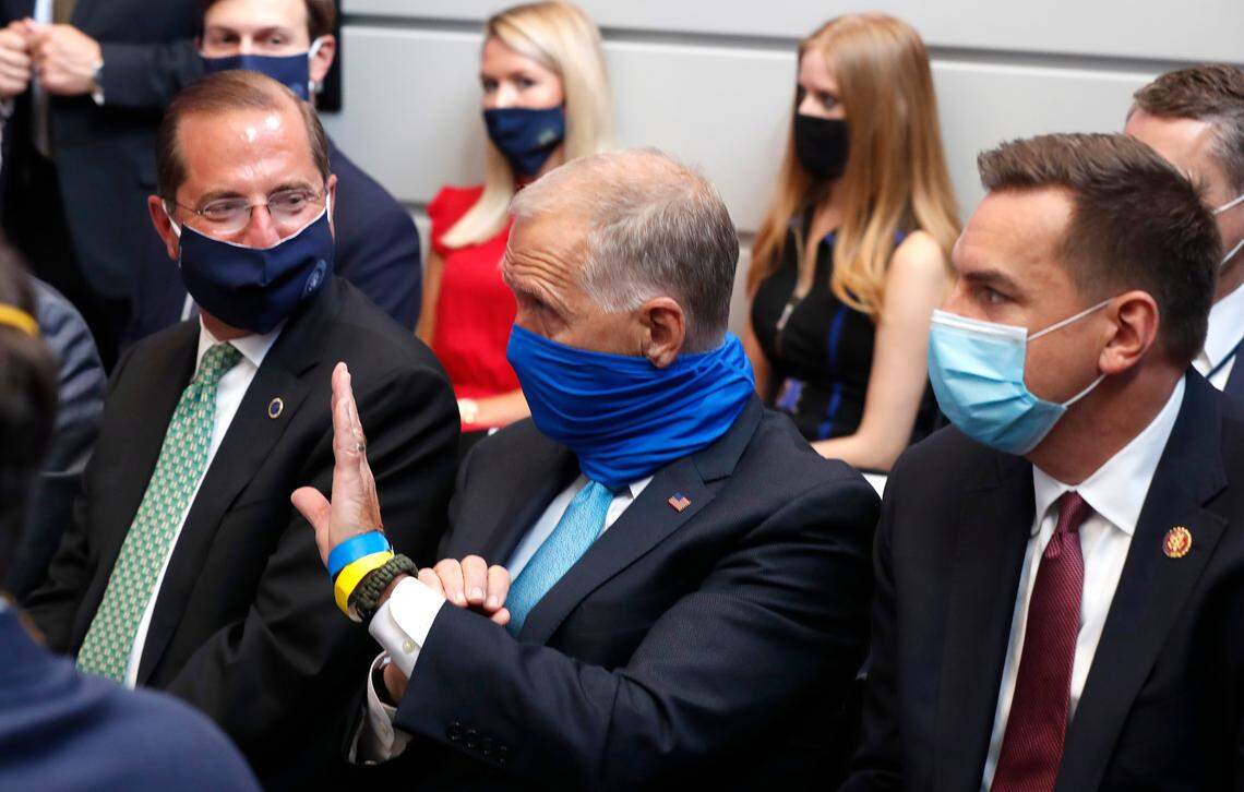 Sen. Thom Tillis acknowledges President Donald Trump during a briefing before taking a tour of the Bioprocess Innovation Center at Fujifilm Diosynth Biotechnologies in Morrisville, N.C., Monday, July 27, 2020. Secretary of Health and Human Services Alex Azar is to the left. U.S. Rep. Richard Hudson is to the right.
