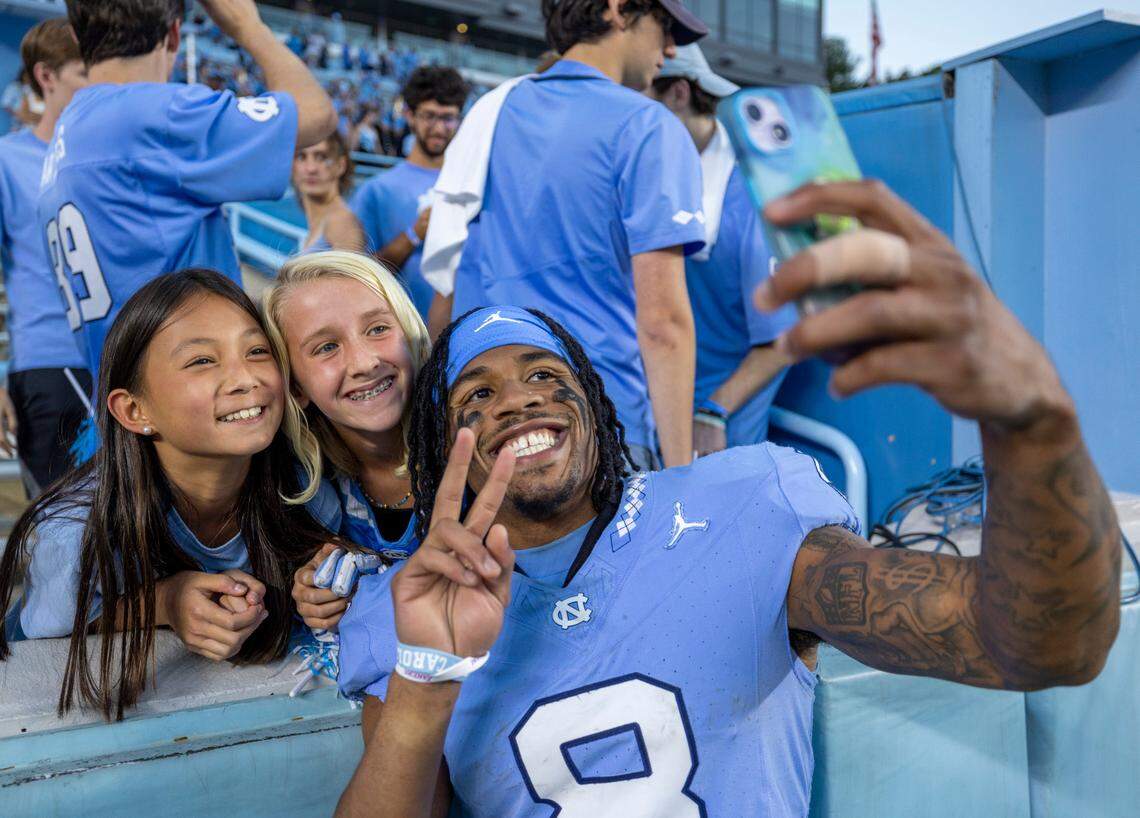 North Carolina’s Kobe Paysour (8) takes a selfie with fans following the Tar Heels’ 40-7 victory over Syracuse on Saturday, October 7, 2023 at Kenan Stadium in Chapel Hill, N.C.