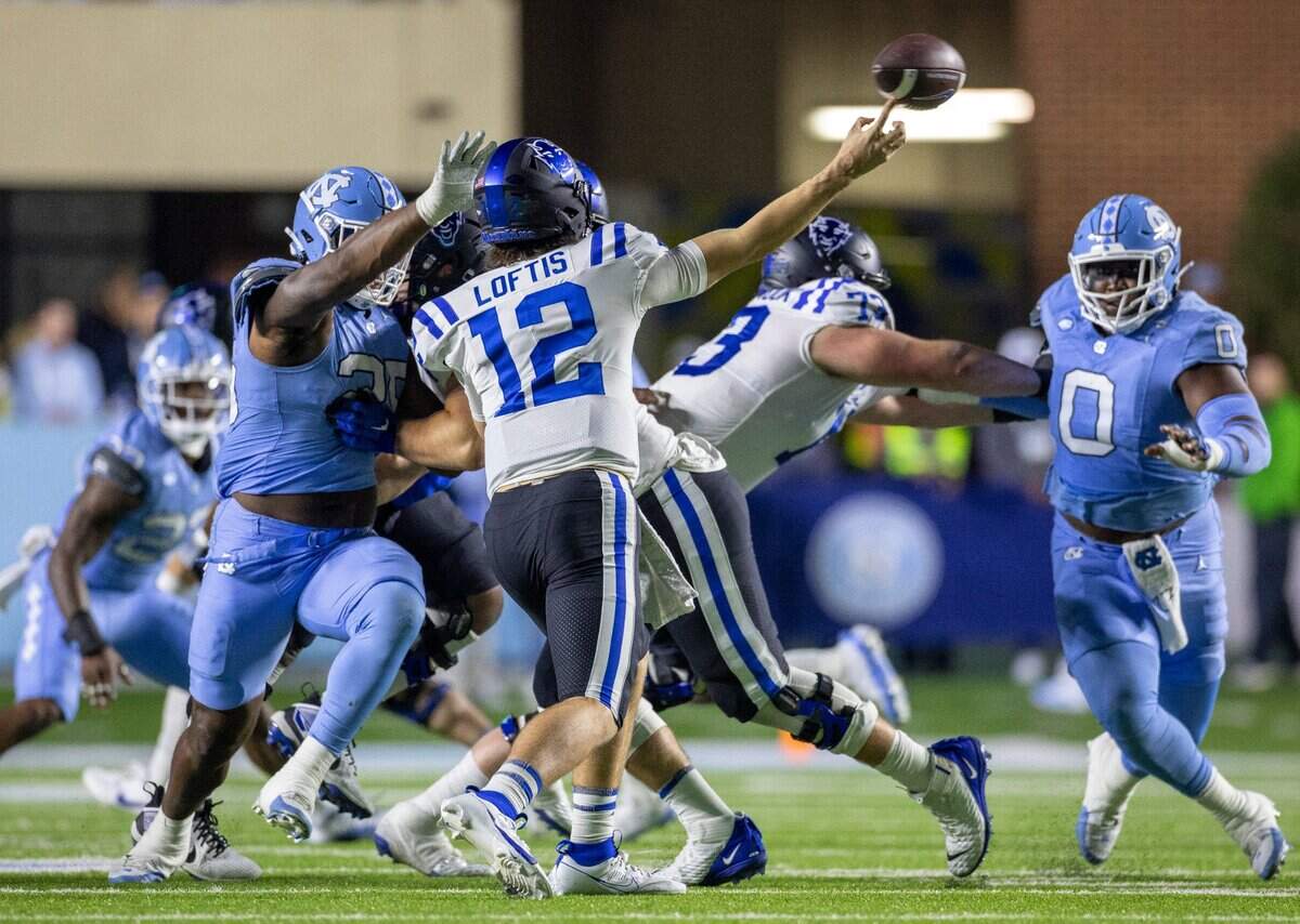 North Carolina’s Kaimon Rucker (25) pressures Duke quarterback Grayson Loftis (12) in the second quarter on Saturday, Nov. 11, 2023 at Kenan Stadium in Chapel Hill, N.C.