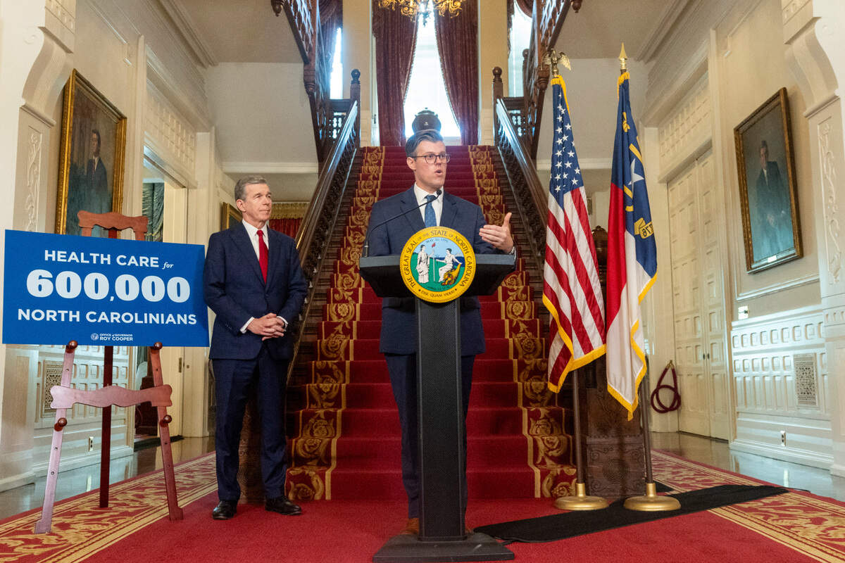 Secretary of Health and Human Services Kody Kinsley speaks as Gov. Roy Cooper looks on  during a press conference at the Executive Mansion on Monday, Set. 25, 2023 announcing a Medicaid expansion launch date of Dec. 1.