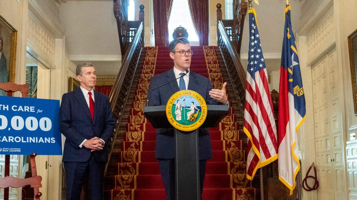 Secretary of Health and Human Services Kody Kinsley speaks as Gov. Roy Cooper looks on during a press conference at the Executive Mansion on Monday, Set. 25, 2023 announcing a Medicaid expansion launch date of Dec. 1.