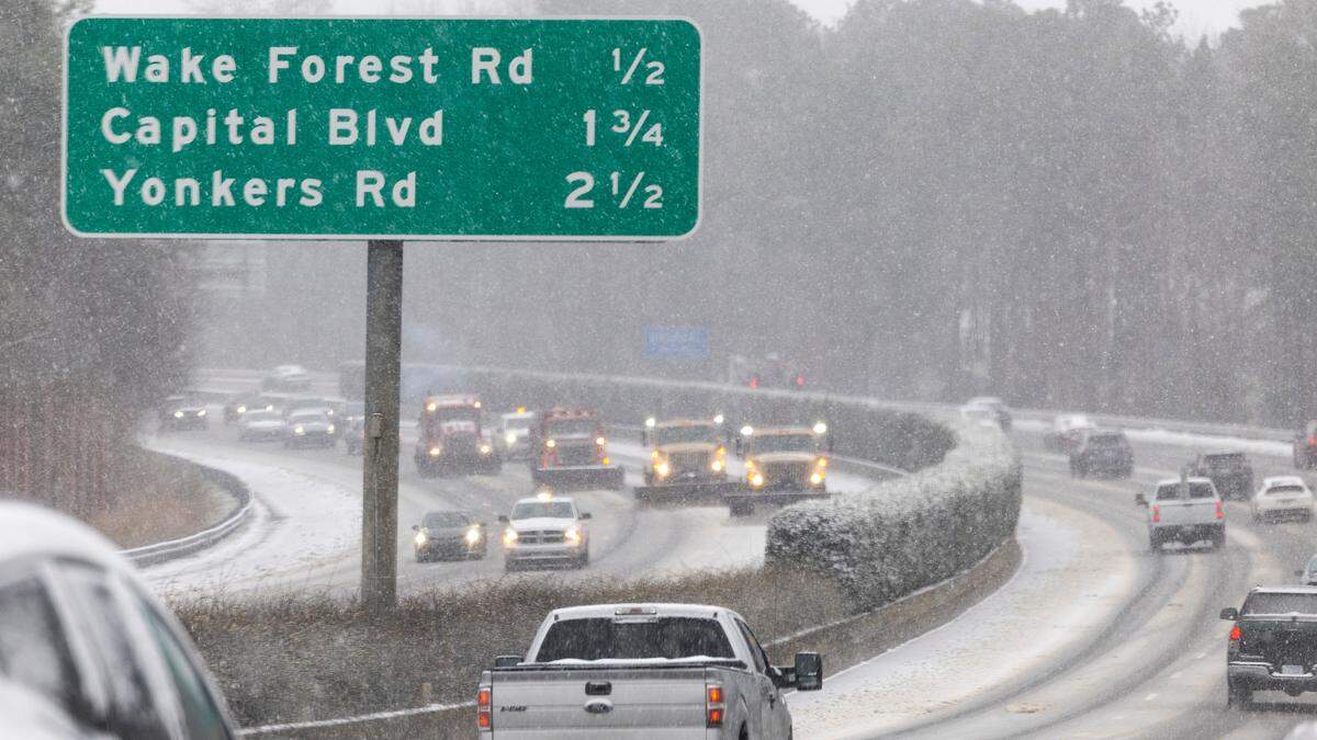 NCDOT trucks plow the outer I-440 Beltline in Raleigh as snow begins to accumulate on Wednesday, Feb. 19, 2024.