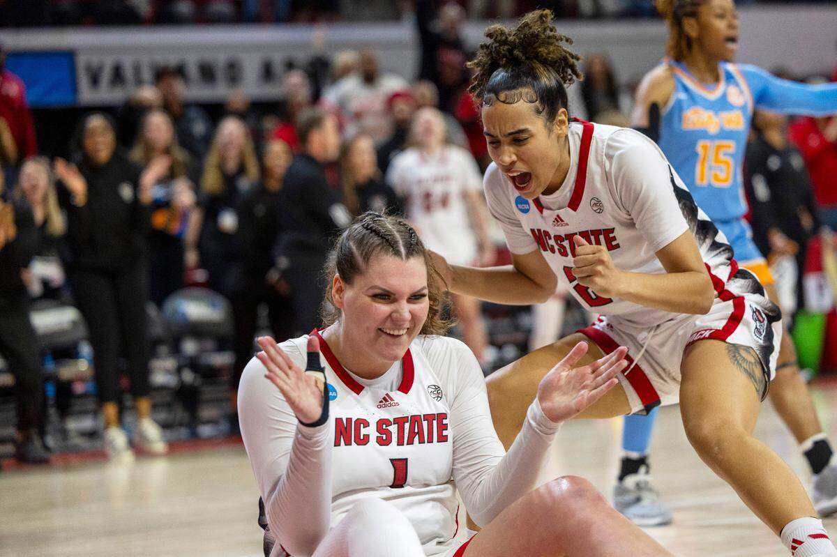 NC State’s River Baldwin (1) and Madison Hayes (21) celebrate after Baldwin was fouled after scoring two late in the second half against Tennessee’s during the second round of the Division I Women’s Basketball Championship at Reynolds Coliseum in Raleigh, North Carolina, on March 25, 2024.