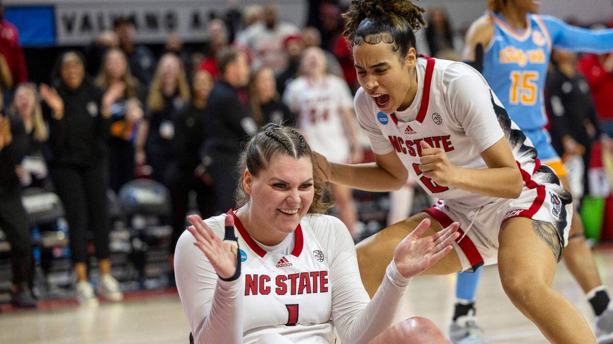 NC State’s River Baldwin (1) and Madison Hayes (21) celebrate after Baldwin was fouled after scoring two late in the second half against Tennessee’s during the second round of the Division I Women’s Basketball Championship at Reynolds Coliseum in Raleigh, North Carolina, on March 25, 2024.