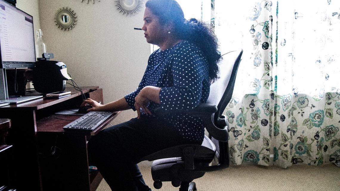 Archana Gopal works in her home office in Morrisville Friday, Nov. 11, 2022. Gopal arrived in North Carolina in 2013 with her two young daughters and husband, Maharajan Shunmugam, who works on a H-1B visa as a software engineer. In 2021, USCIS informed Gopal that her work authorization renewal would be delayed.