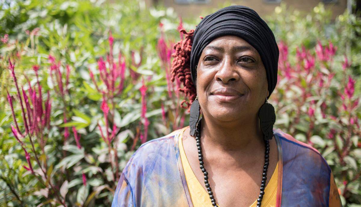 Vannessa Mason Evans stands for a portrait in a garden outside of her office in Durham, N.C. on Wednesday, Sept. 16, 2020. Between March and September, Evans lost eight people to COVID-19.
