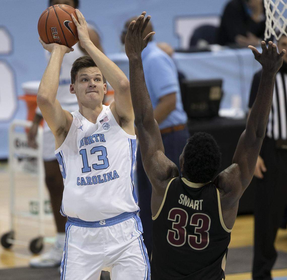 North Carolina’s Walker Kessler (13) puts up a shot over College of Charleston’s Osinachi Smart (33) during the second half on Wednesday, November 25, 2020 at the Smith Center in Chapel Hill, N.C. Kessler scored six points in his debut with the Tar Heels.