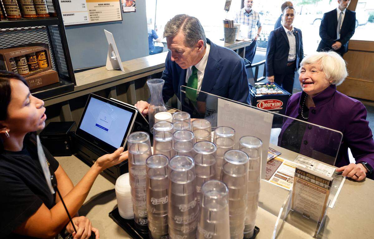 U.S. Secretary of the Treasury Janet Yellen talks with Vicky Becerra as N.C. Gov. Roy Cooper pays for lunch at Sam Jones BBQ in Raleigh Thursday, Sept. 5, 2024.