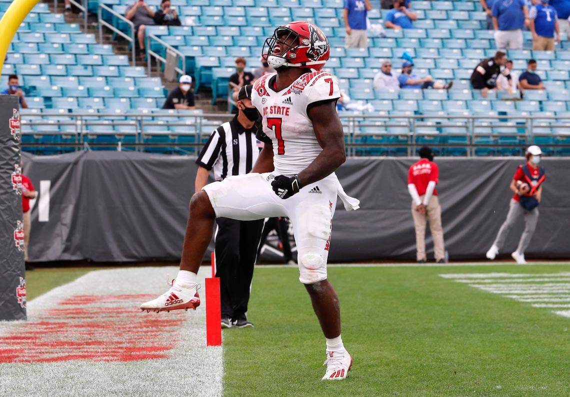 N.C. State running back Zonovan ‘Bam’ Knight (7) celebrates after scoring on 13-yard touchdown run during the second half of Kentucky’s 23-21 victory over N.C. State in the Gator Bowl at TIAA Bank Field in Jacksonville, Fla., Saturday, January 2, 2021.