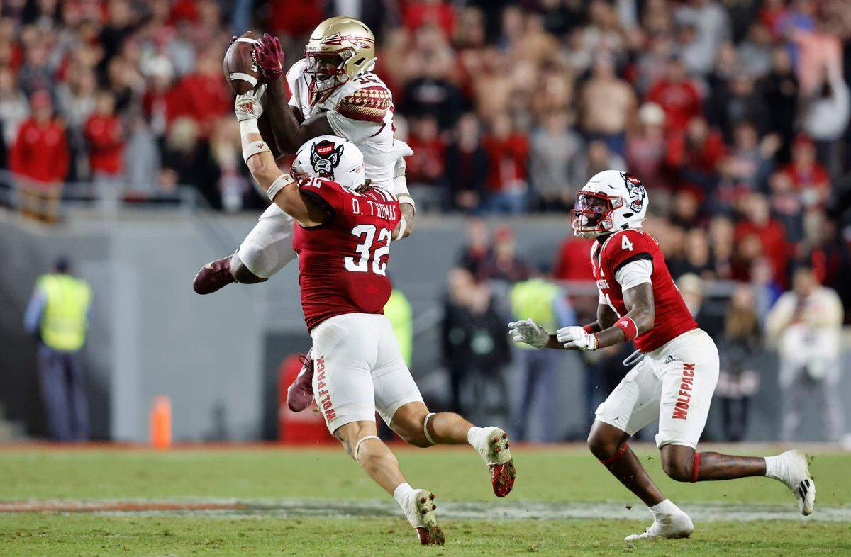 N.C. State linebacker Drake Thomas (32) breaks up the pass intended for Florida State wide receiver Fernando Padron (84) during the second half of N.C. State’s 19-17 victory over Florida State at Carter-Finley Stadium in Raleigh, N.C., Saturday, Oct. 8, 2022.