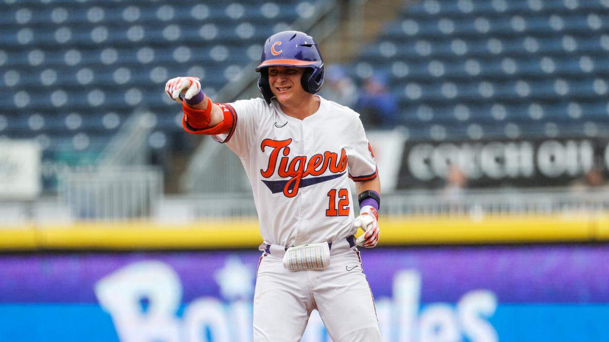 Clemson’s Cooper Ingle points to his teammates in the dugout the Tigers’ 11-5 win over Miami in the 2023 ACC baseball championship final at Durham Bulls Athletic Park on Sunday.