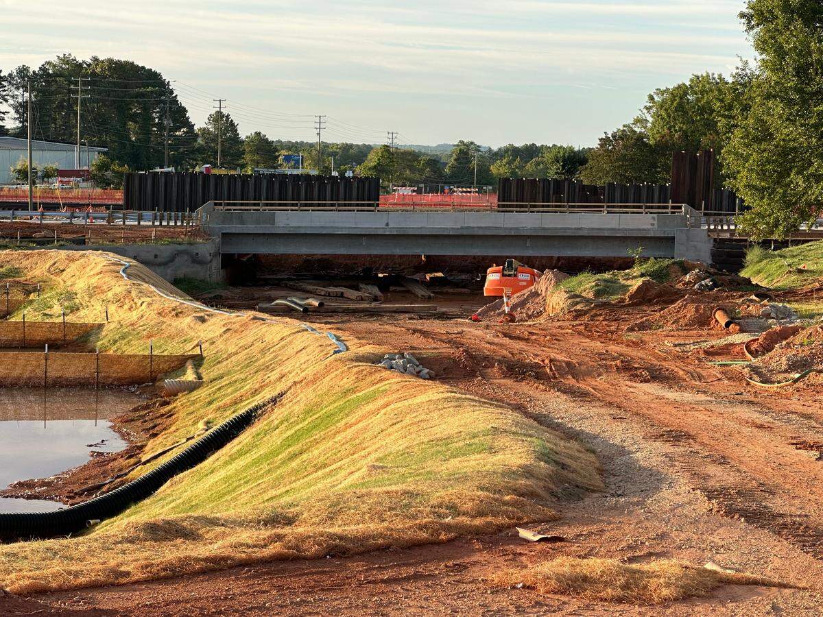 The new bridge on Hillsborough Street, set to open by Sept. 6, passes over bare earth. The area under the bridge will be excavated so Blue Ridge Road can pass under Hillsborough Street, Beryl Road and the railroad tracks that run alongside them.