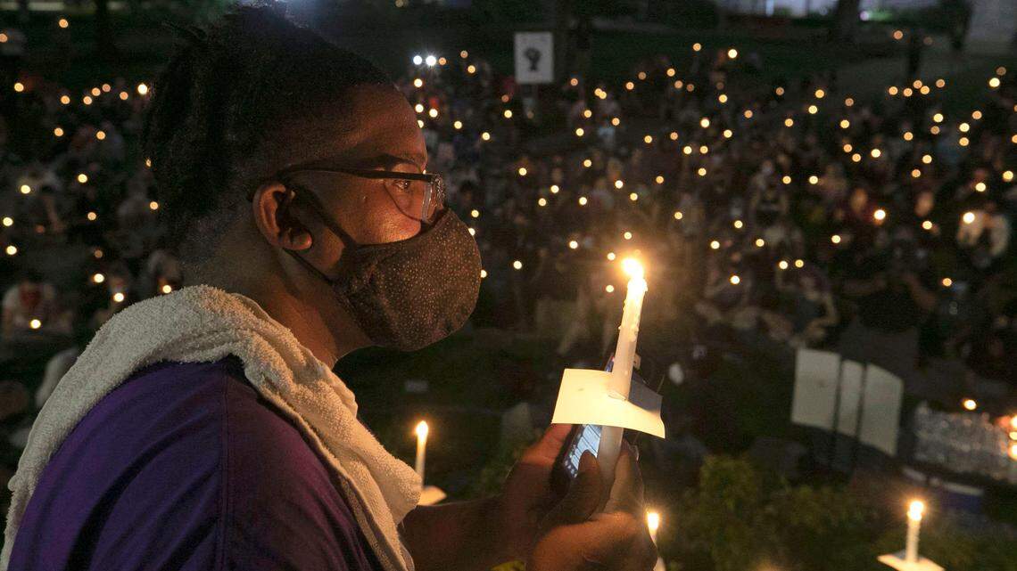 Gary Hines of Raleigh, N.C. participates in a candlelight vigil for George Floyd, with several hundred others on the State Capital grounds on Sunday, June 7, 2020 in Raleigh, N.C.