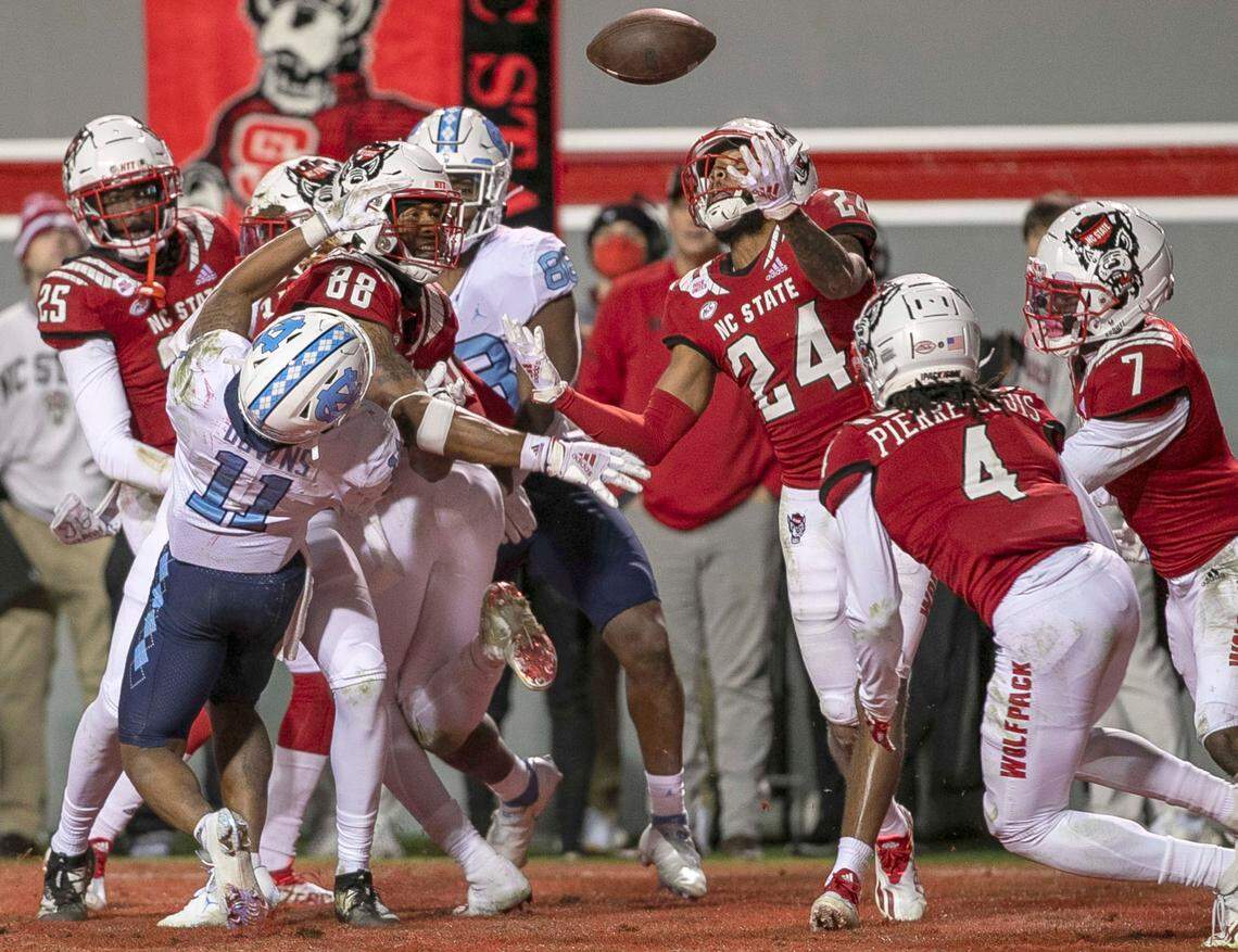 N.C. State’s Derrek Pitts, Jr. (24) intercepts a Sam Howell pass on the final play of the game to secure the Wolfpack’s 34-30 victory over North Carolina on Friday, November 26, 2021 at Carter-Finley Stadium in Raleigh, N.C.