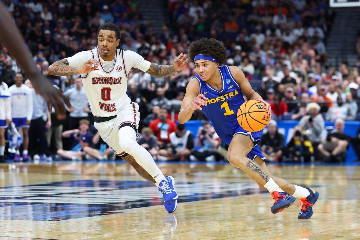 Preston Edmead, right, of the Hofstra Pride drives to the basket against Labaron Philon Jr. of the Alabama Crimson Tide during the teams’ first-round game in the 2026 NCAA Men’s Basketball Tournament at Benchmark International Arena on March 20, 2026 in Tampa, Florida.