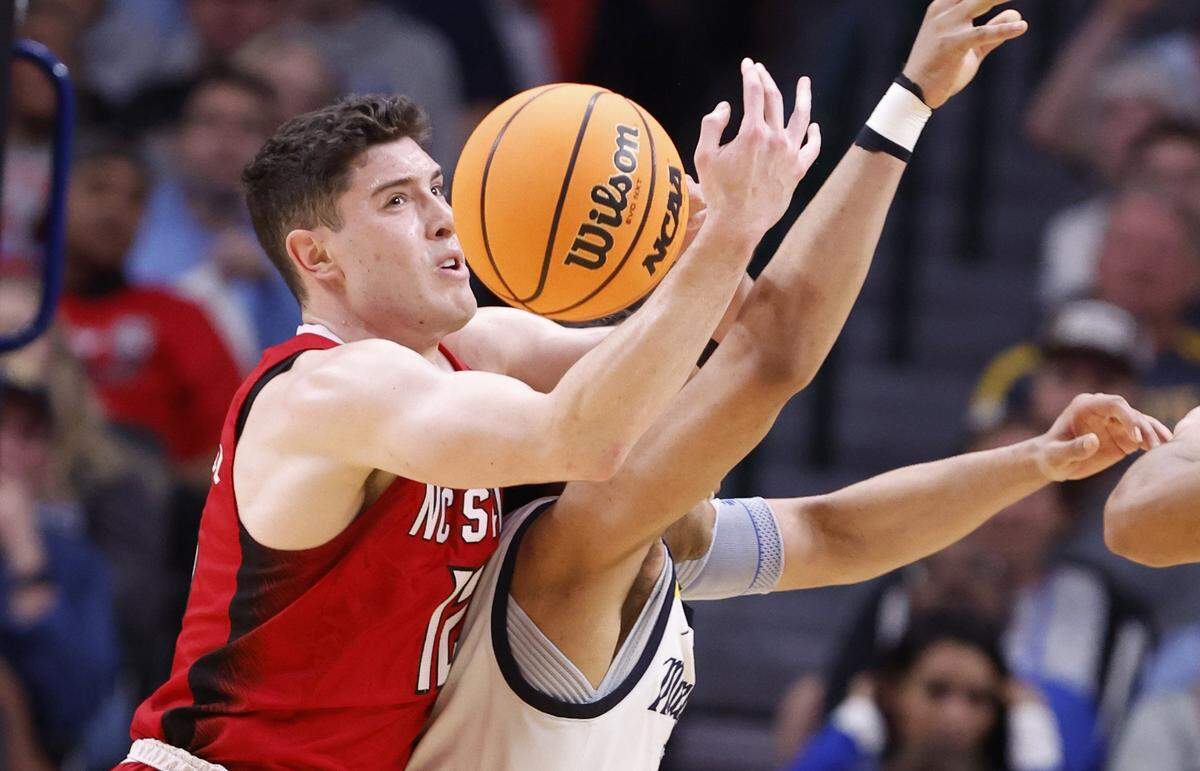 N.C. State’s Michael O’Connell (12) tries to pull in the rebound from Marquette’s Stevie Mitchell (4) during the second half of N.C. State’s 67-58 victory over Marquette in their NCAA Tournament Sweet 16 game at the American Airlines Center in Dallas, Texas, Friday, March 29, 2024.