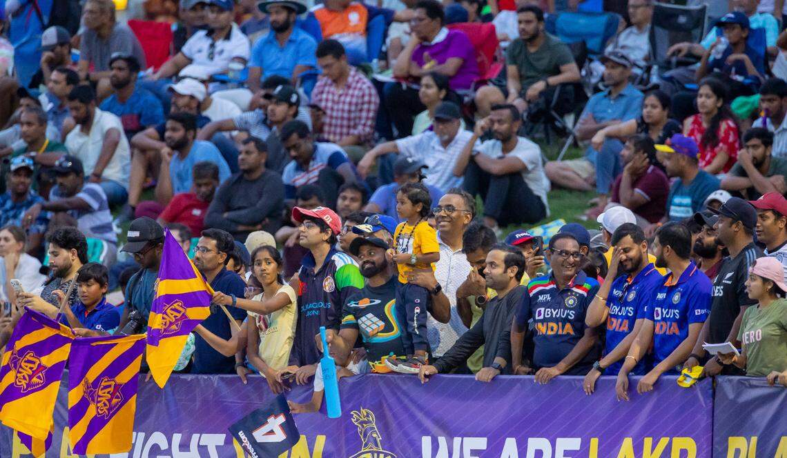 Fans crowd around the boundary of the of the oval field to watch a Major League Cricket match between the Washington Freedom and the LA Knight Riders on Thursday, July 20, 2023 at Church Street Park in Morrisville, N.C.