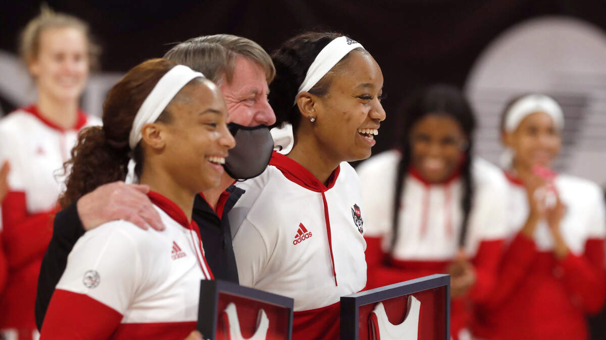 N.C. State head coach Wes Moore poses with seniors Kai Crutchfield, left, and Kayla Jones during senior day activities before N.C. State’s game against Pittsburgh at Reynolds Coliseum in Raleigh, N.C., Thursday, February 25, 2021.