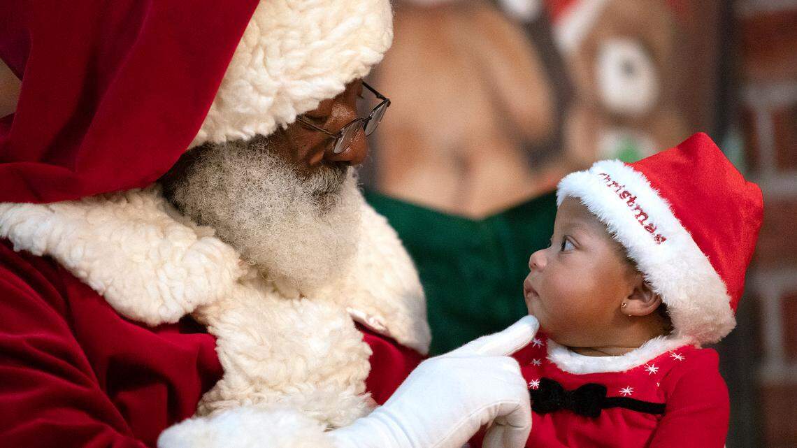 Seven-month-old Ameris Augustin visits with Santa during a Santas Just Like Me event at Hayti Heritage Center on Friday, Dec. 22, 2023, in Durham, N.C.