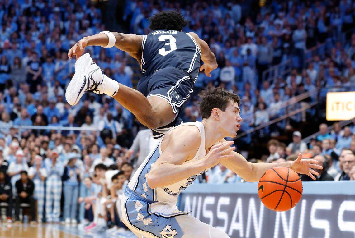 North Carolina’s Cormac Ryan (3) is fouled by Duke’s Jeremy Roach (3) during the first half of Duke’s game against UNC at the Smith Center in Chapel Hill, N.C., Saturday, Feb. 3, 2024.