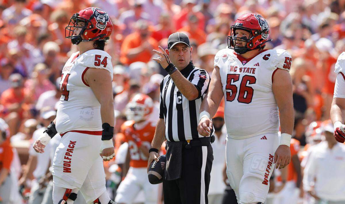 N.C. State’s Val Erickson (54) and Zeke Correll (56) walk back after the Wolfpack were called for holding during the first half of N.C. State’s game against Clemson at Memorial Stadium in Clemson, S.C., Saturday, Sept. 21, 2024.