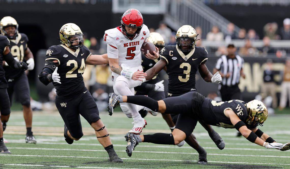N.C. State quarterback Brennan Armstrong (5) leaps for more yards during a run in the first half of N.C. State’s game against Wake Forest at Allegacy Stadium in Winston-Salem, N.C., Saturday, Nov. 11, 2023.