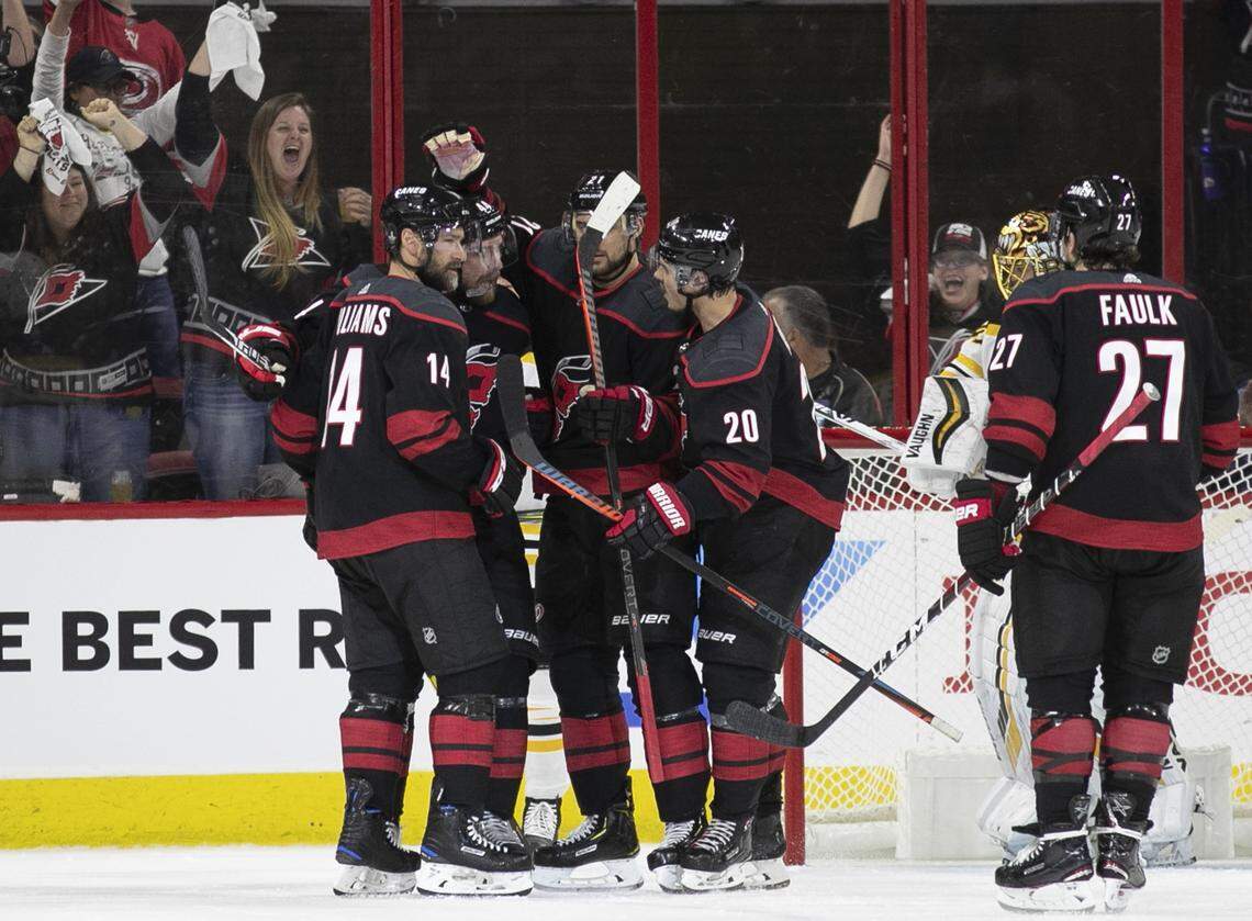Carolina Hurricanes’ Calvin de Haan (44) is surrounded by teammates after scoring during the second period of Game 3 of the Eastern Conference finals on Tuesday, May 14, 2019 at PNC Arena in Raleigh, N.C.