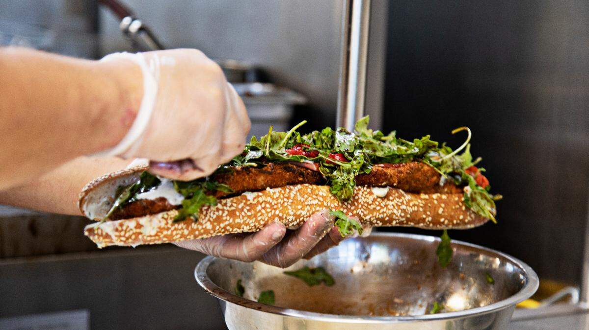 Paul Chirico makes a sandwich for a customer at Ideal’s Sandwich & Grocery in Durham on Thursday, Sept. 23, 2021, during lunch. The eatery sells a variety of hot and cold sandwiches served on house-made bread.