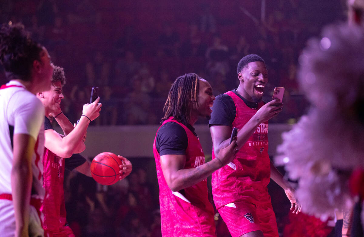Players react during a dunk contest at the “Primetime with the Pack” preseason event on Thursday, Oct. 26, 2023, at Reynolds Coliseum in Raleigh, N.C.