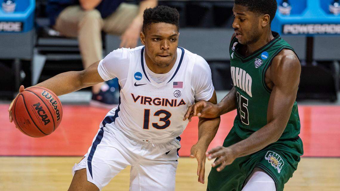 Virginia guard Casey Morsell (13) makes a move along the baseline around the defense of Ohio guard Lunden McDay (15) during the second half of a first-round game in the NCAA men’s college basketball tournament, Saturday, March 20, 2021, at Assembly Hall in Bloomington, Ind.
