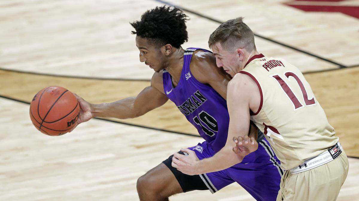 Furman’s Alex Hunter (10) steals the ball from Elon’s Nathan Priddy (12) in the second half of an NCAA college basketball game in Elon, N.C., Tuesday, Dec. 4, 2018.