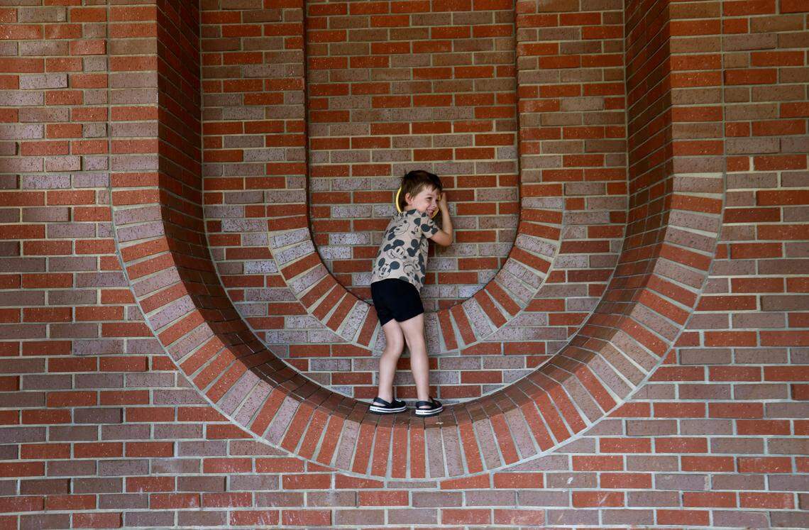 Jack Gulledge, 4, of Raleigh listens to a person at the other end of a talk tube at Gipson Play Plaza at Dix Park during a preview day Saturday, May 24, 2025. The park will officially open with a grand opening celebration on June 6th, 7th and 8th.