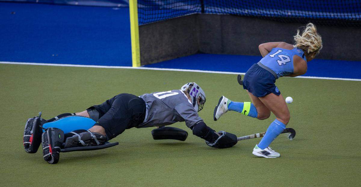North Carolina’s Katie Dixon (14) scores on Northwestern goalie Annabel Skubisz (30) in the sudden death shootout during the NCAA Division I Field Hockey Championship on Sunday, November 19, 2023 at Karen Shelton Stadium in Chapel Hill, N.C.