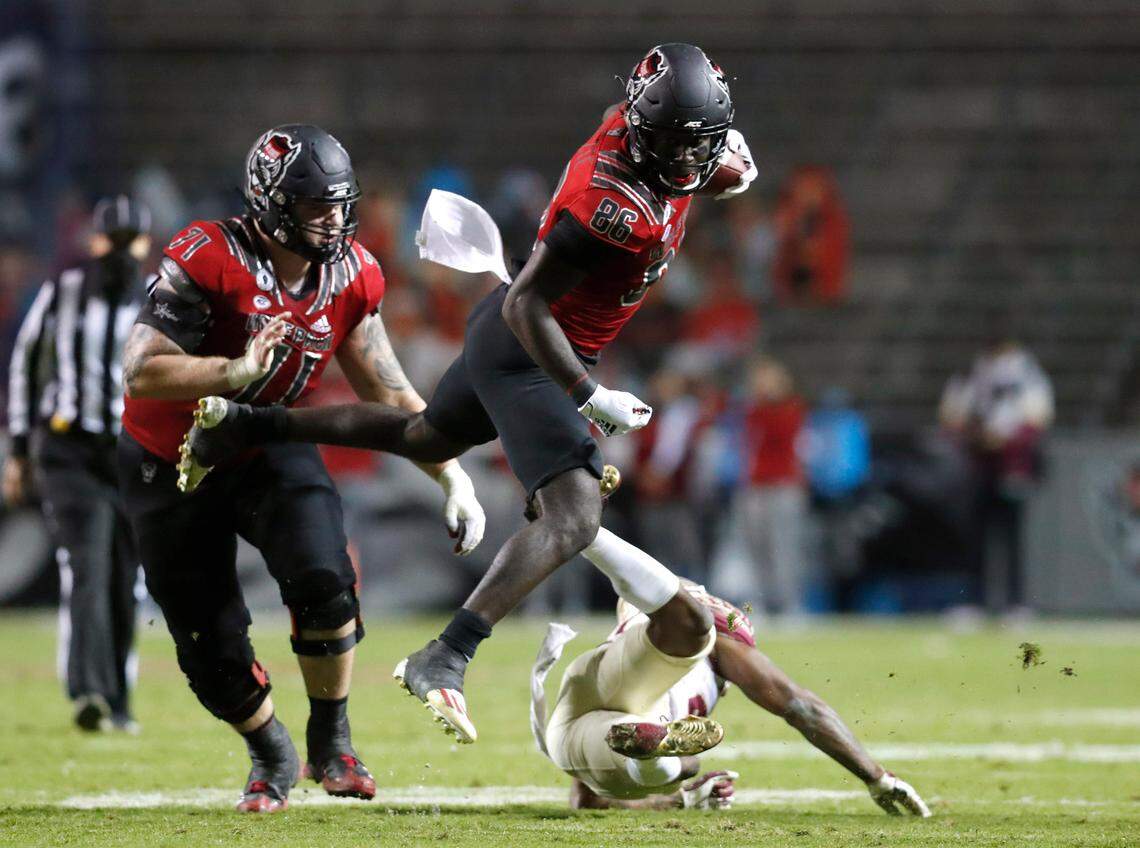 N.C. State wide receiver Emeka Emezie (86) flies over Florida State defensive back Asante Samuel Jr. (26) during the second half of N.C. State’s 38-22 victory over Florida State at Carter-Finley Stadium in Raleigh, N.C., Saturday, Nov. 14, 2020.