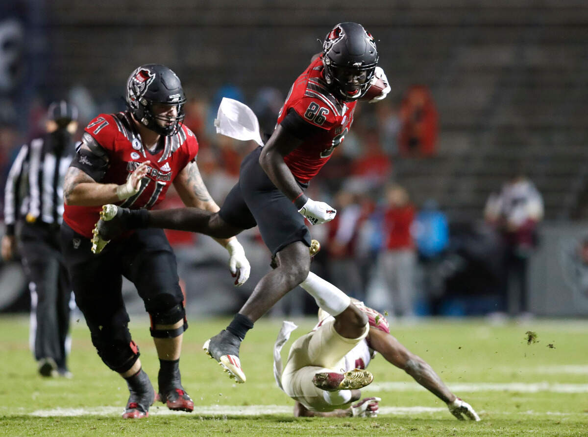 N.C. State wide receiver Emeka Emezie (86) flies over Florida State defensive back Asante Samuel Jr. (26) during the second half of N.C. State’s 38-22 victory over Florida State at Carter-Finley Stadium in Raleigh, N.C., Saturday, Nov. 14, 2020.