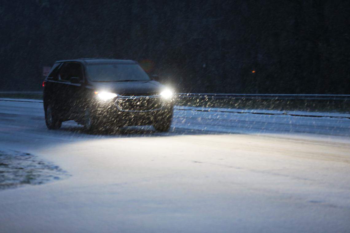 A car drives through pouring snow on Highway 15-501 in Chapel Hill, N.C. Sunday morning, Jan. 16 2022.