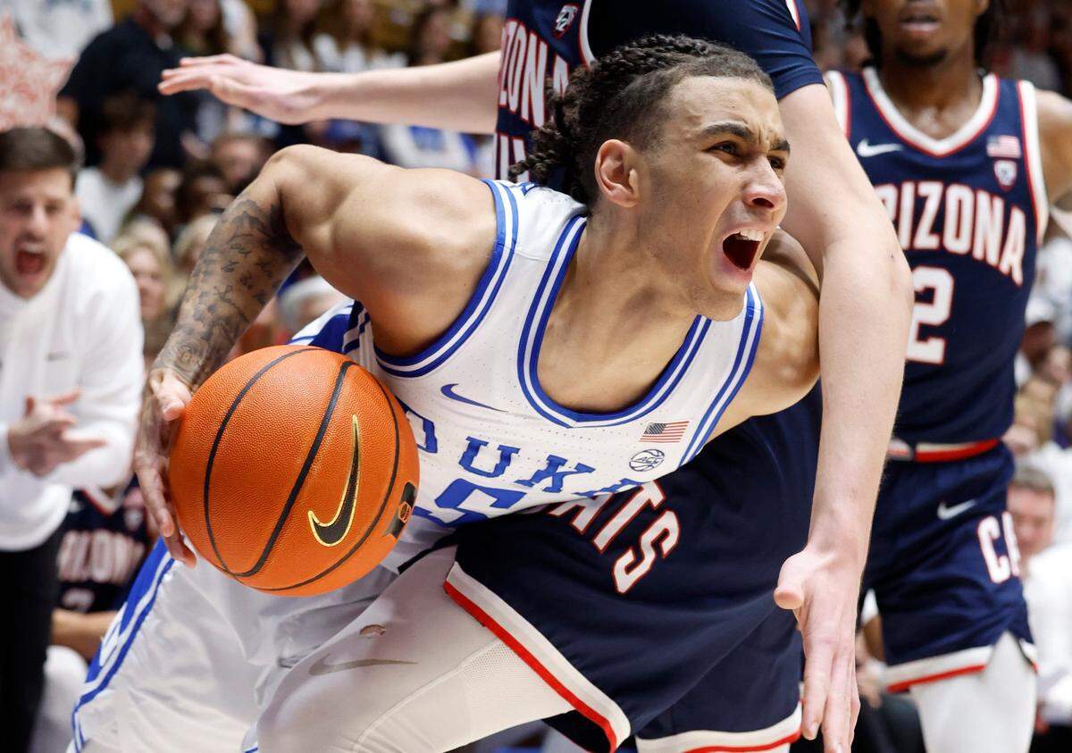 Duke’s Tyrese Proctor (5) is fouled by Arizona’s Motiejus Krivas (14) during the first half of Duke’s game against Arizona at Cameron Indoor Stadium in Durham, N.C., Friday, Nov. 10, 2023.