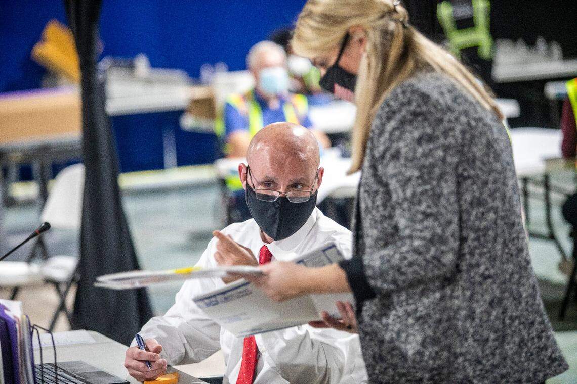 Election workers process absentee ballots Tuesday, Nov. 10, 2020 at the Wake County Board of Elections Operations Center in Raleigh.